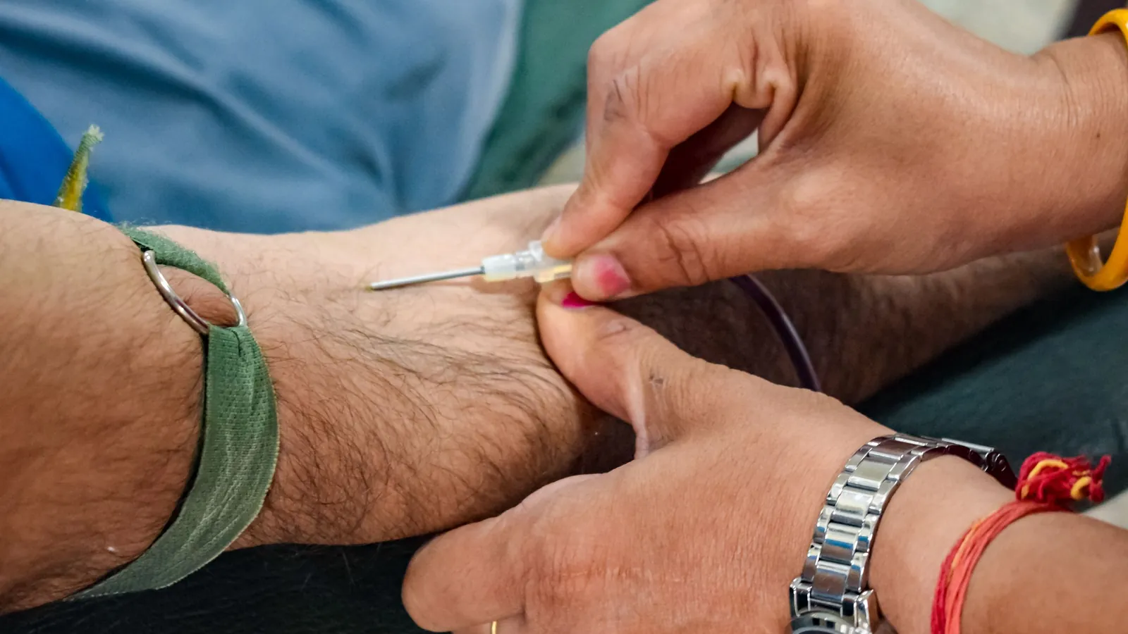 Close-up of a needle being placed into a person's forearm